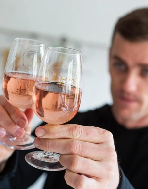 A man holding two glasses of a pink wine from Untitled Wines