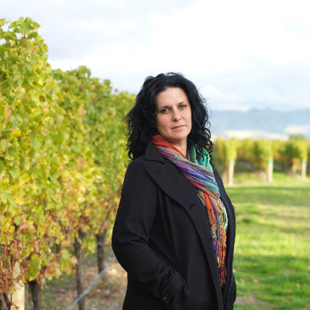 Siobhan Wilson standing in a vineyard
