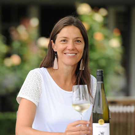 Kirsten Searle holding a glass of white wine
