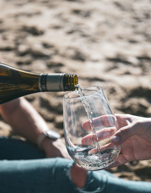 A glass being filled with Sauvignon Blanc