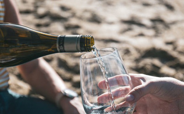 A glass being filled with Sauvignon Blanc