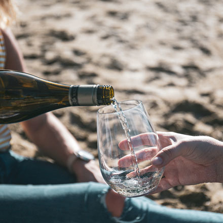 A glass being filled with Sauvignon Blanc