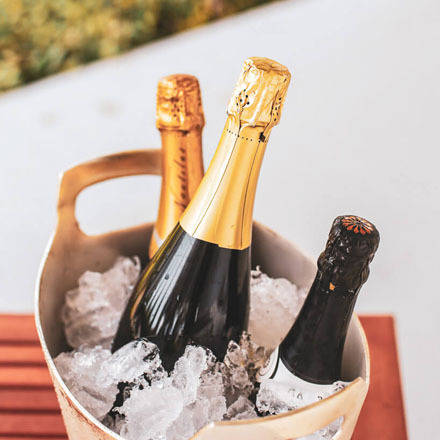 Sparkling wines in an ice bucket.