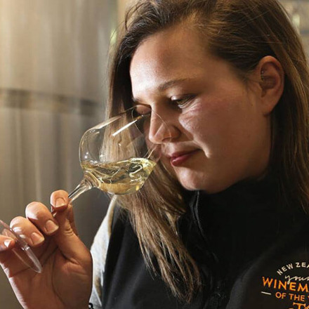 Women smelling a glass of wine.