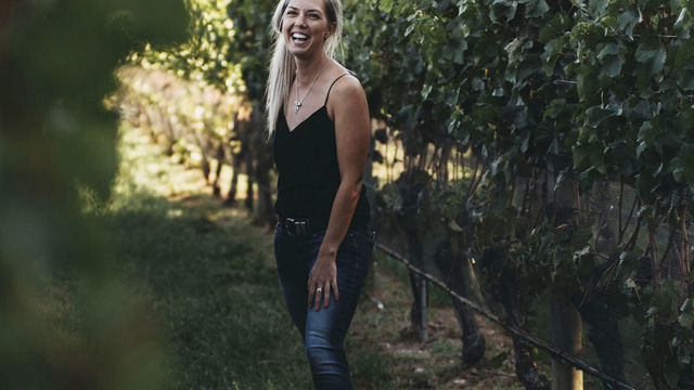 Alice Rule standing in vine rows