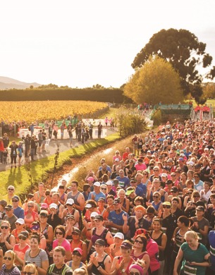 A large crowd of people getting ready to start a half marathon