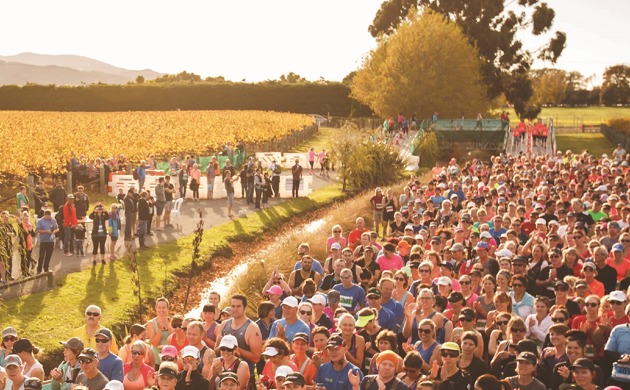 A large crowd of people getting ready to start a half marathon