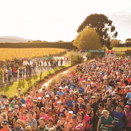 A large crowd of people getting ready to start a half marathon